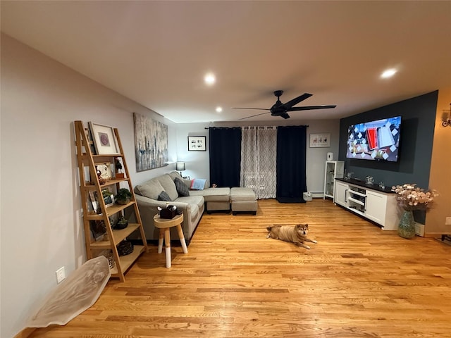 living room with ceiling fan, baseboards, light wood-style flooring, and recessed lighting