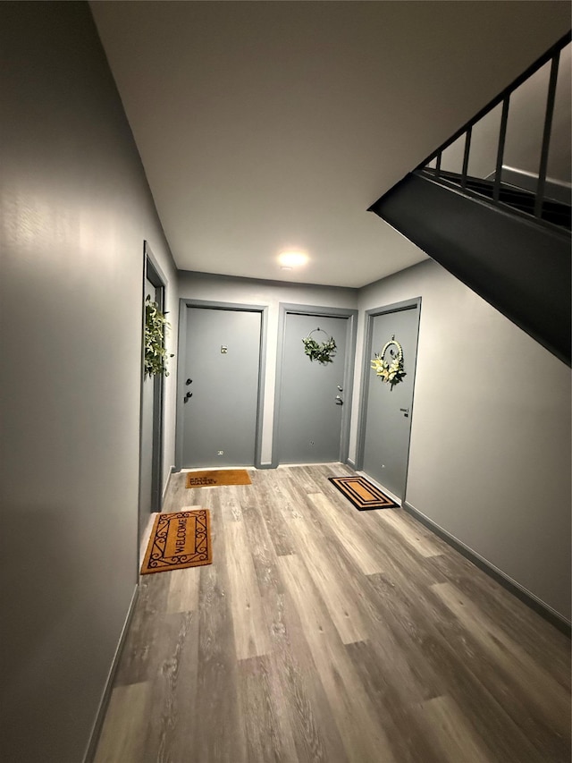 entryway featuring wood finished floors and baseboards