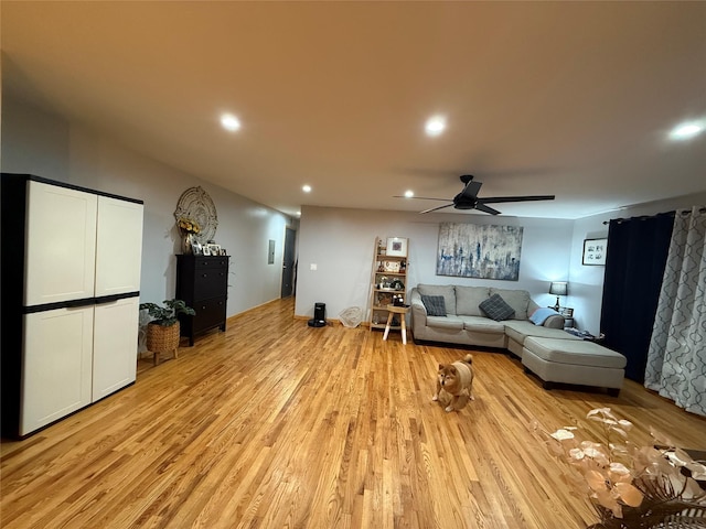 living room featuring ceiling fan, light wood-type flooring, and recessed lighting