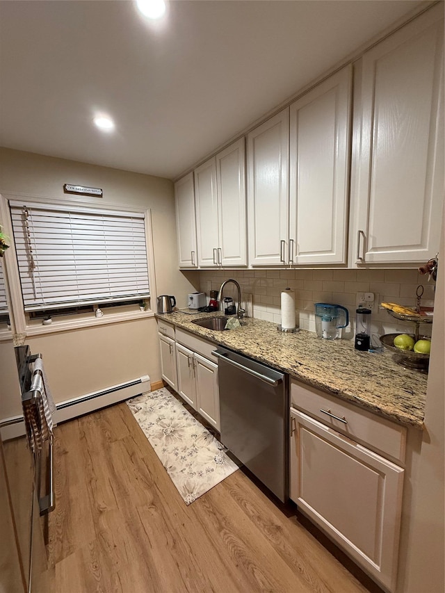 kitchen featuring light wood-type flooring, baseboard heating, dishwasher, and a sink