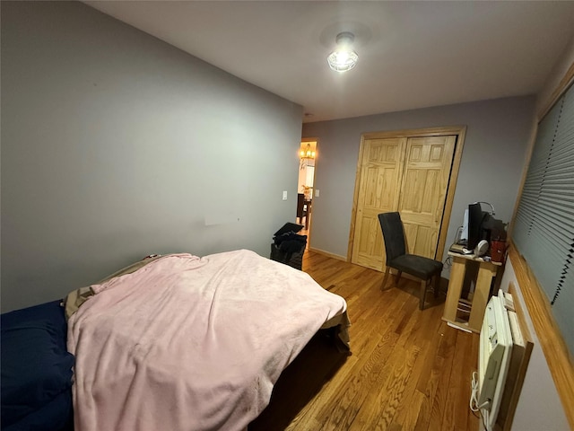 bedroom featuring an AC wall unit and light wood-type flooring