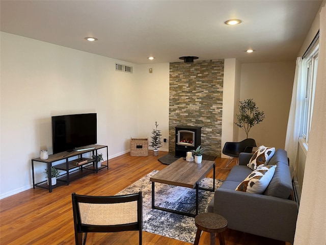 living area with baseboards, visible vents, wood finished floors, and recessed lighting