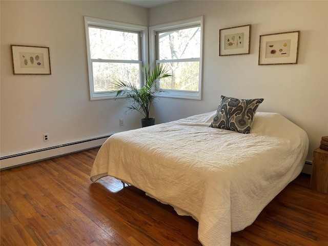 bedroom featuring a baseboard radiator and wood finished floors