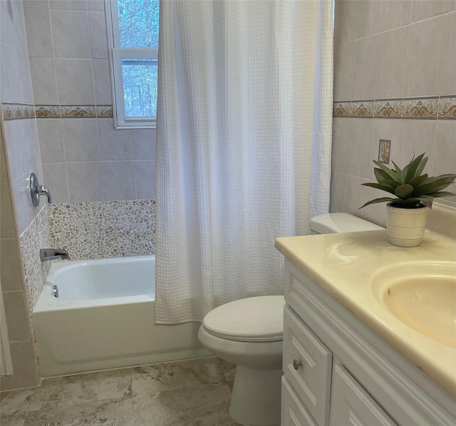 bathroom with toilet, shower / bath combo, tile walls, and vanity