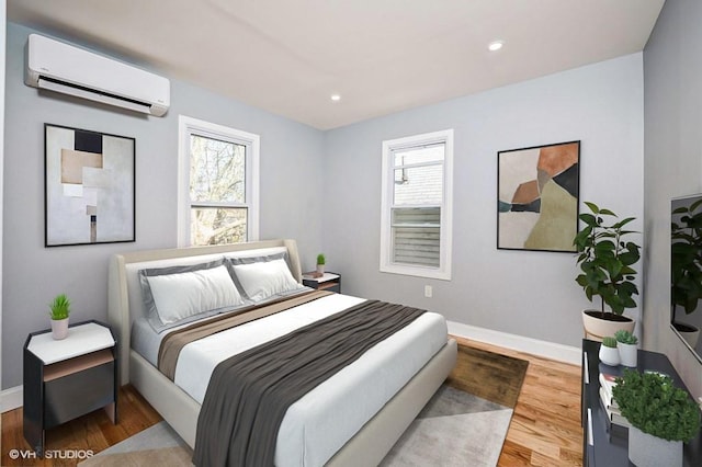 bedroom with recessed lighting, a wall mounted AC, baseboards, and wood finished floors