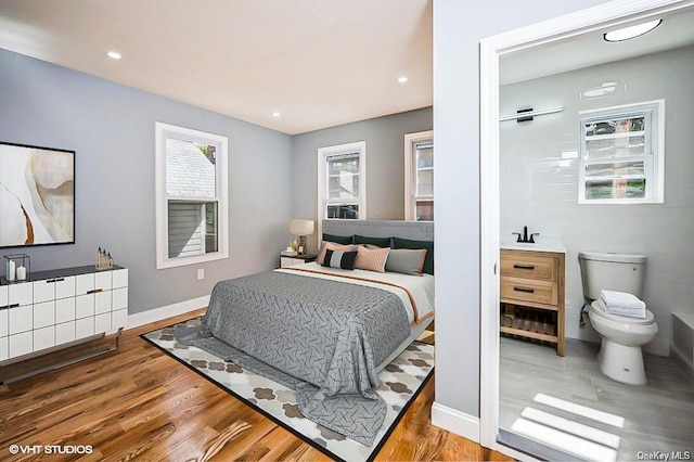 bedroom with recessed lighting, baseboards, and wood finished floors