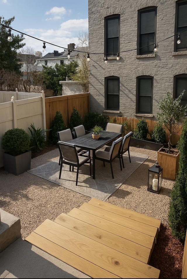 view of patio with outdoor dining area and fence