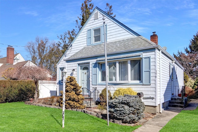 bungalow with a chimney, roof with shingles, a front yard, and fence