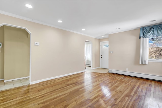 unfurnished room featuring a baseboard heating unit, crown molding, light wood-style flooring, and recessed lighting