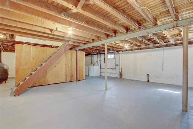 basement with washing machine and clothes dryer, stairway, and heating fuel