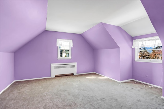 bonus room featuring radiator heating unit, a healthy amount of sunlight, baseboards, and carpet floors