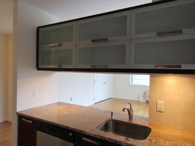 kitchen with a sink and light stone countertops