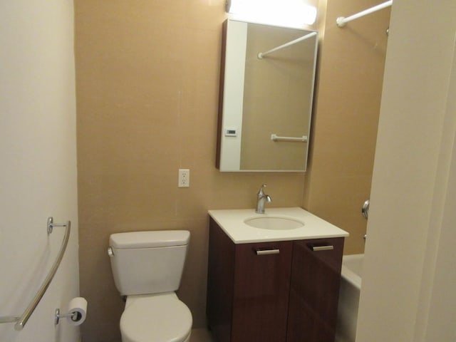 full bath featuring toilet, washtub / shower combination, and vanity