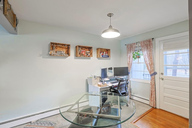 home office featuring baseboard heating and wood finished floors