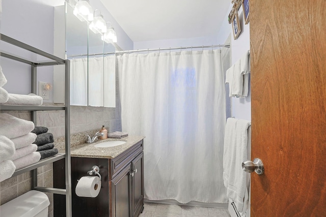 bathroom with decorative backsplash, a shower with shower curtain, toilet, tile patterned floors, and vanity