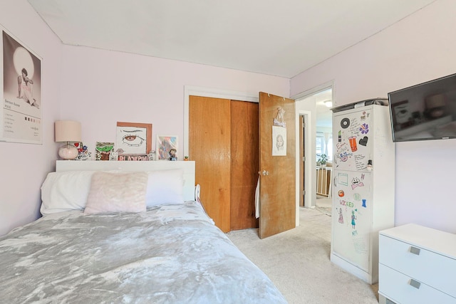 bedroom with freestanding refrigerator and light colored carpet