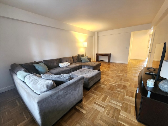 living area featuring baseboards