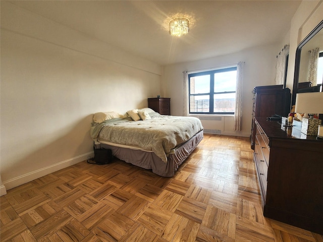 bedroom featuring baseboards and radiator