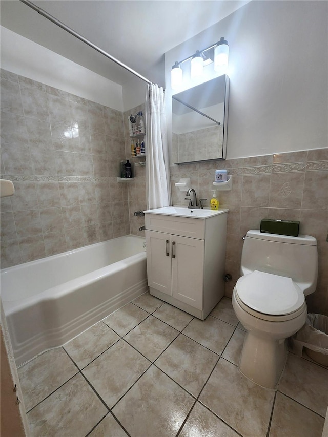 bathroom featuring toilet, vanity, tile walls, tile patterned floors, and shower / bath combo