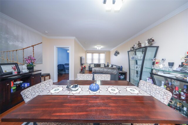 dining room featuring crown molding and wood finished floors