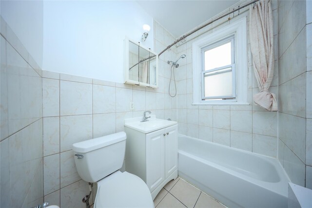 full bath featuring tile patterned flooring, tile walls, toilet, bathing tub / shower combination, and vanity