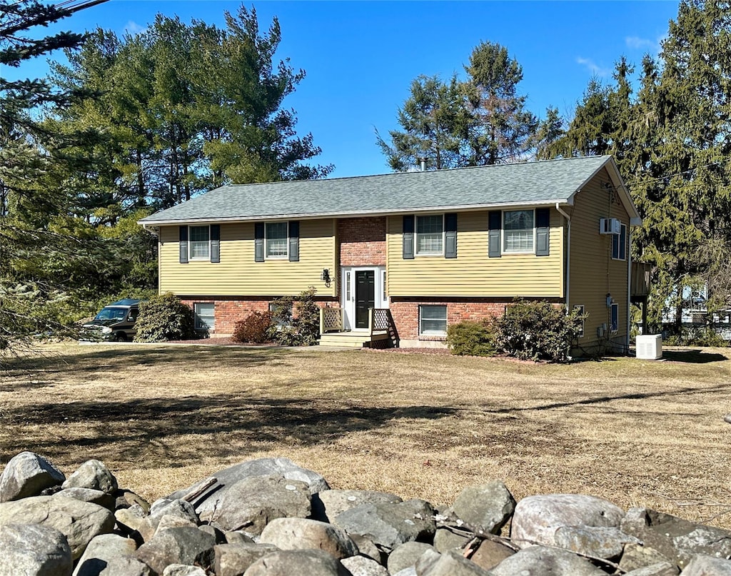 raised ranch with brick siding and central AC