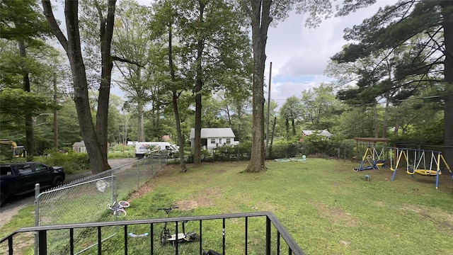 view of yard with fence and a playground