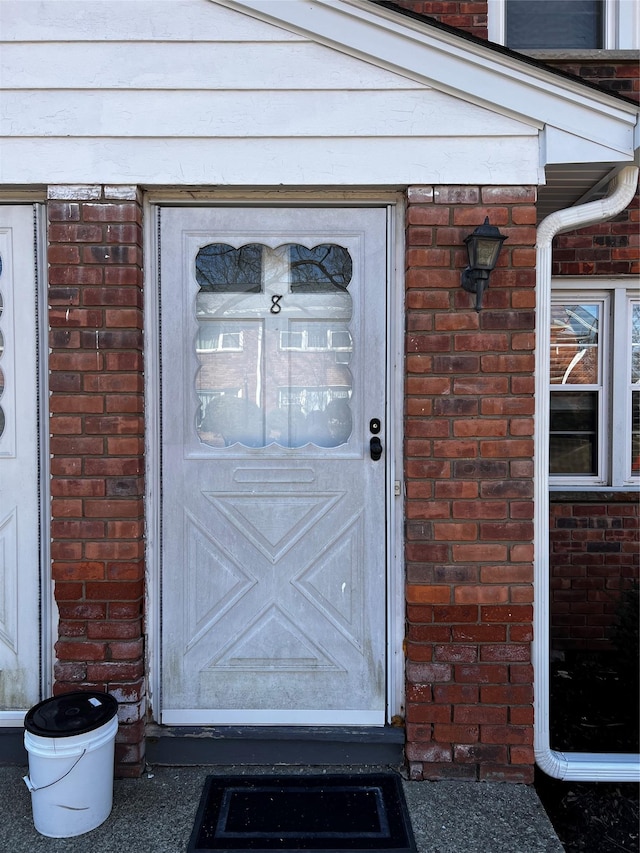 property entrance with brick siding