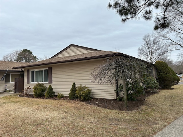 view of side of home featuring a yard