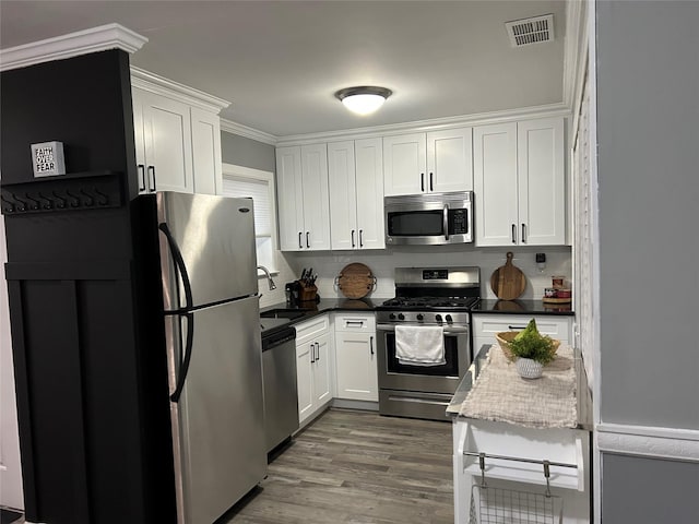 kitchen featuring white cabinetry, visible vents, stainless steel appliances, and a sink