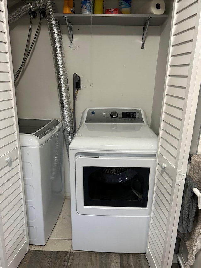 laundry area featuring laundry area, light wood-style flooring, and washer and clothes dryer