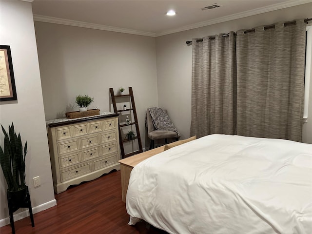 bedroom featuring ornamental molding, visible vents, dark wood finished floors, and baseboards