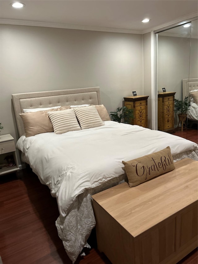 bedroom with ornamental molding, recessed lighting, a closet, and wood finished floors