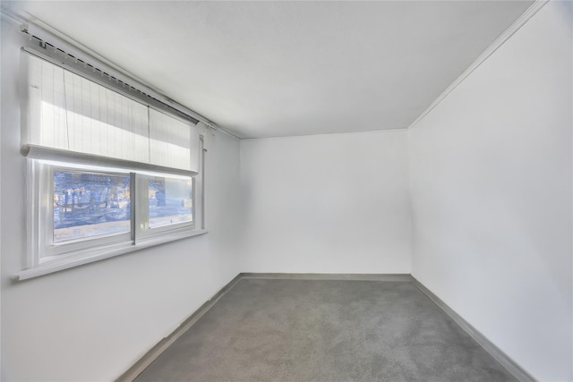 carpeted spare room featuring baseboards