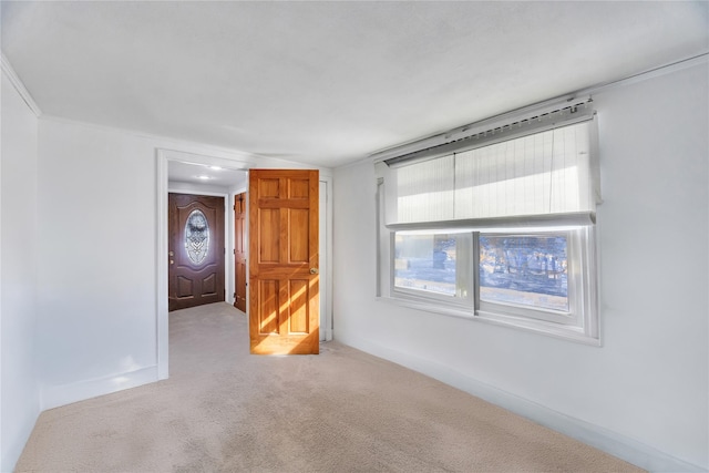 carpeted empty room with baseboards