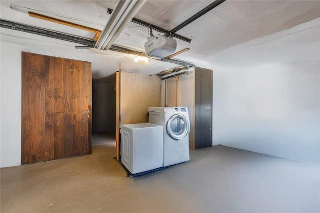 clothes washing area featuring laundry area, separate washer and dryer, and a garage