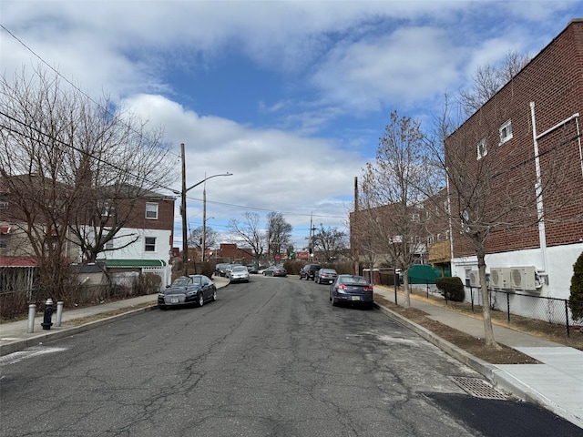 view of road with curbs, sidewalks, and street lights