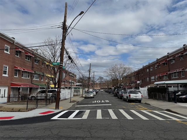 view of street featuring curbs, sidewalks, and street lights