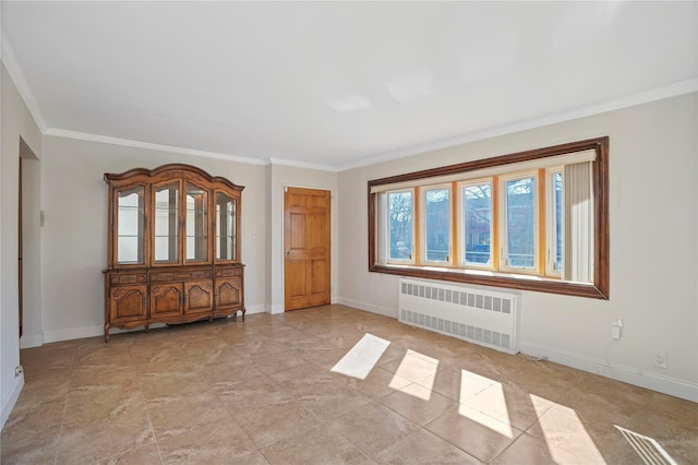 spare room with baseboards, crown molding, and radiator heating unit