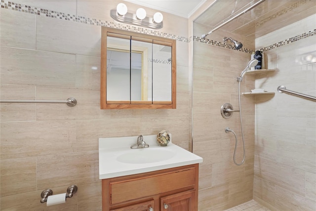 bathroom featuring tiled shower and vanity