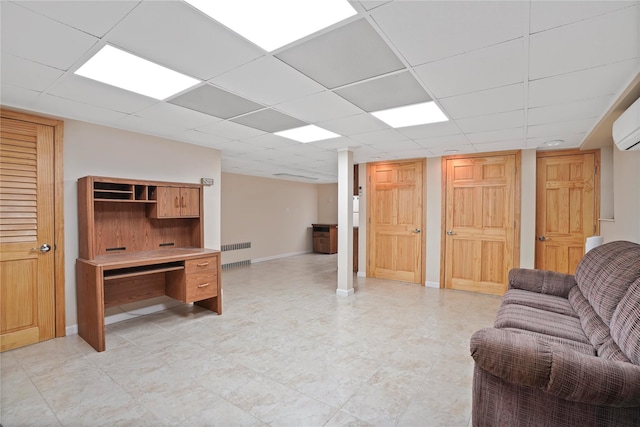 living area featuring a paneled ceiling, radiator, and baseboards