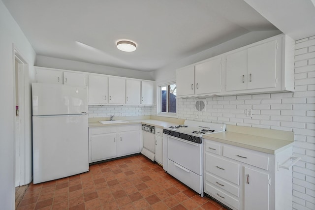 kitchen featuring white appliances, a sink, white cabinets, light countertops, and decorative backsplash