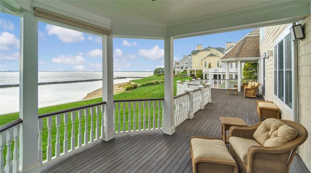 deck featuring a yard and a water view