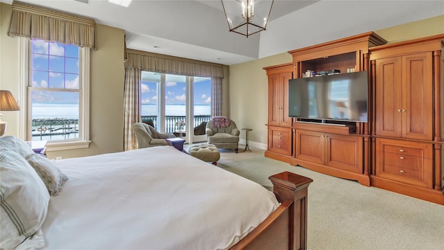 bedroom with light colored carpet, access to outside, a notable chandelier, and multiple windows