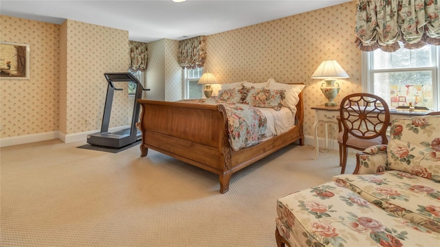bedroom featuring wallpapered walls, baseboards, carpet flooring, and multiple windows
