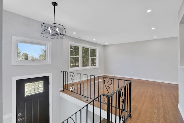 entryway with recessed lighting, wood finished floors, baseboards, and a chandelier