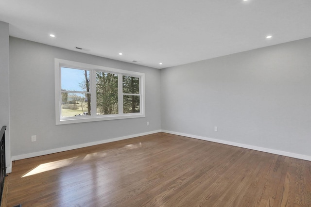 unfurnished living room featuring recessed lighting, baseboards, and wood finished floors