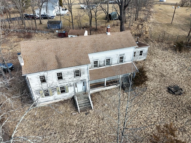 rear view of property with roof with shingles