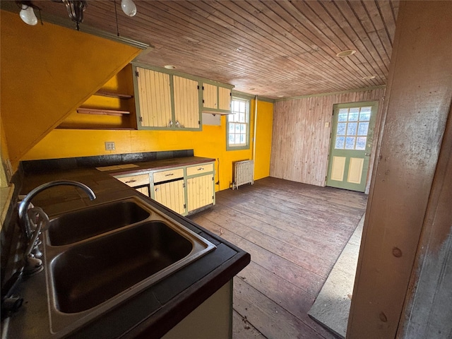 kitchen featuring a sink, dark countertops, radiator, wooden ceiling, and dark wood-style flooring