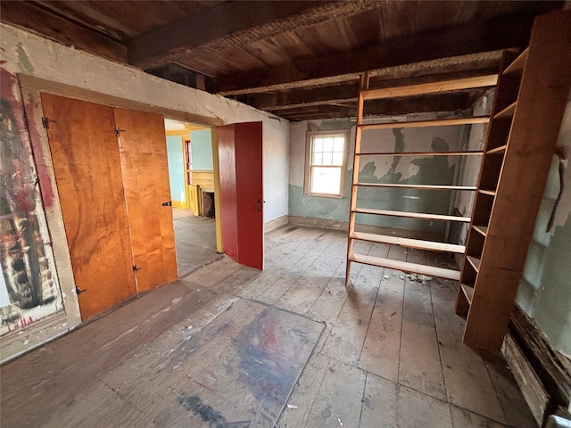 interior space with beam ceiling, wooden ceiling, and wood-type flooring